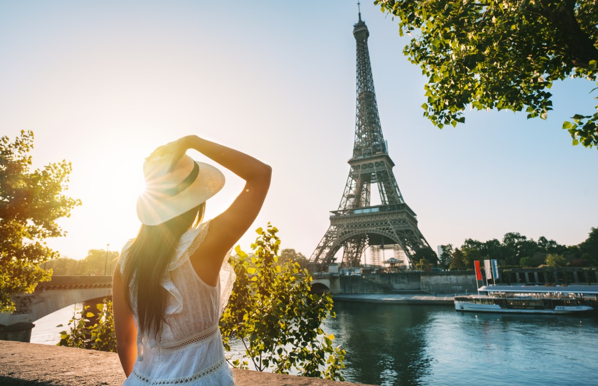Woman admiring Eiffel Tower at sunset