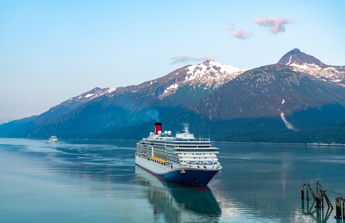 Ship approaching mountainous coastline