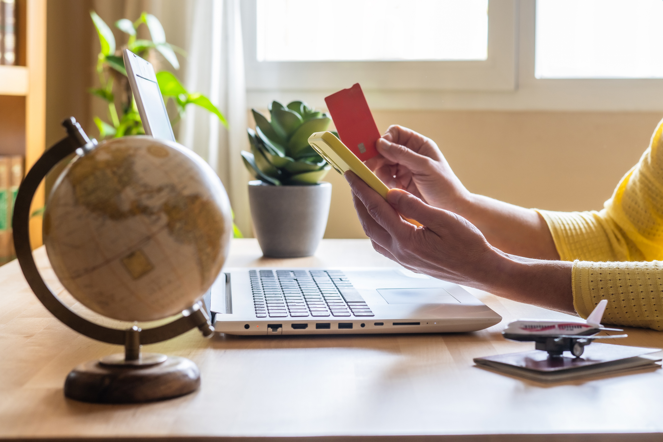 Person shopping online with laptop and card.