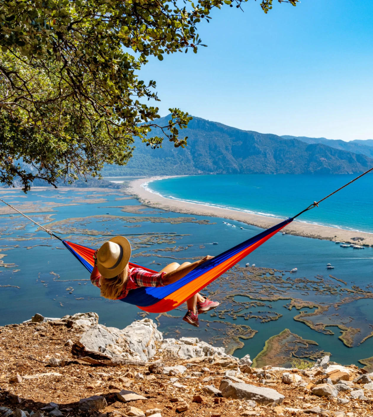 Scenic coastal view with hammock and sea.