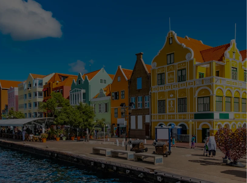 Brightly painted Dutch colonial architecture by water